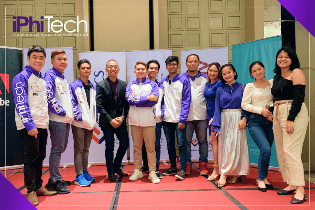 group of iPhiTech representatives at a business fair, with other company banners in the background